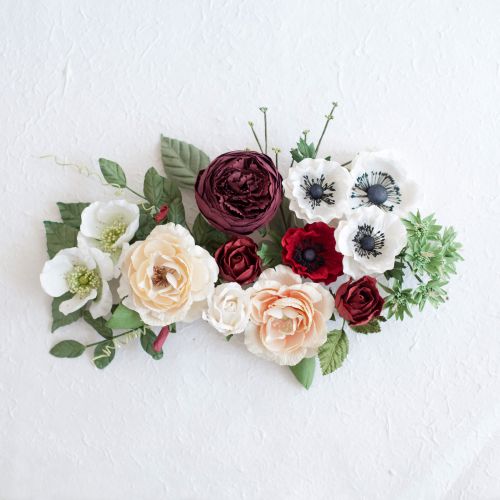 Floral arrangement with red, white, and green flowers on a white background