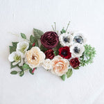 Floral arrangement with red, white, and green flowers on a white background